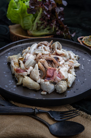 Close-up of Fresh grilled squid, Octopus tentacles and Squids eggs on Ceramic plate Served with...
