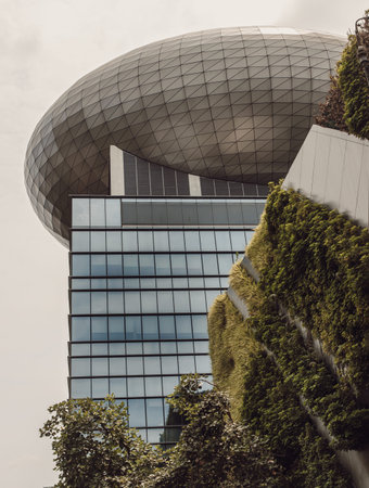 Bangkok, thailand - Mar 18, 2022 : Architectural View of Modern high rise building design of glass and concrete with Fern and green plants decorate on wall in front of. Selective focus.のeditorial素材