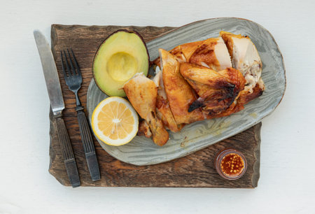 Grilled chicken or Roasted chicken with Avocado and Lemon cut in half serve with Sweet chili sauce....