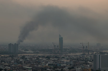 Bangkok, Thailand - 08 Apr, 2022 : Plume of black smoke clouds from Burnt buildings on fire at some...