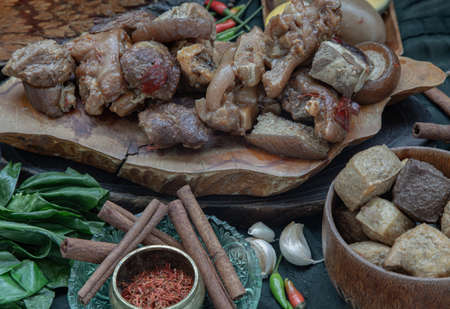 Stewed pork leg, Boiled eggs, Tofu and Kale with Spices on wooden background. Selective focus.の写真素材