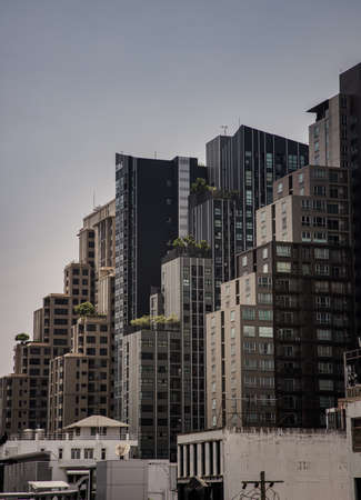Bangkok,Thailnad - Apr 14, 2022 : Architectural view of Overlapping city skyscrapers. Beautiful of Modern high-rise buildings with repeating structure glass and reflected. Angular geometric of building design, Focus and blur.のeditorial素材