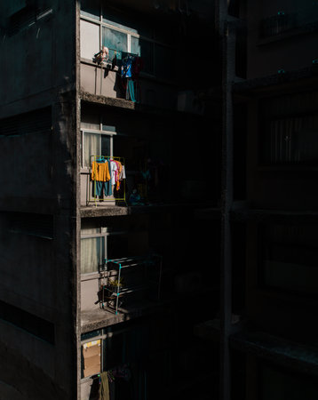 Bangkok, Thailand - Apr 22, 2022 : Old apartment with Iron clothes rack for Hanging drying clothes washed outside the windows at rooms. Empty black space to put message, Selective focus.のeditorial素材