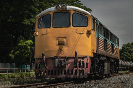 Front view of The diesel electric locomotive is parked on Old railroad tracks. The empty passenger...