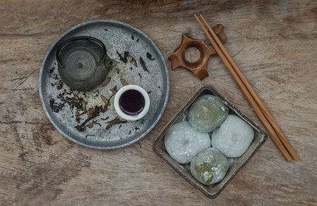 Green tea and Red bean daifuku with chinese tea on old wooden background. Japanese tradiitonal...