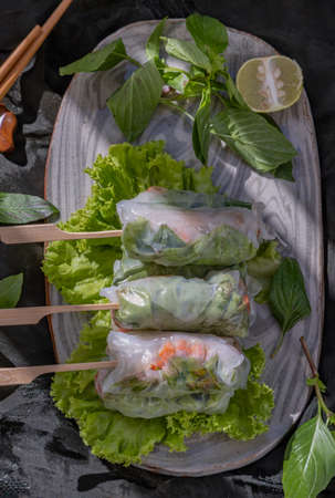 Healthy vietnamese spring rolls as portion stuff vegetable on ceramic plate. Top view, Selective focus.の写真素材