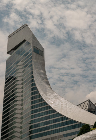 Bangkok, Thailand - May 13, 2022 : Sky and buidings reflection on Glass wall of modern tall building with repeating structure. Exterior architecture of modern building, View from the outside, Copy space, Selective focus.のeditorial素材