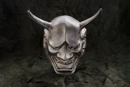 Traditional japanese mask of a demon on dark background. The mask shadow kabuki is a classical...