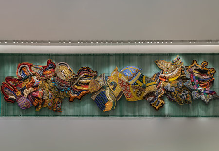 Bangkok, Thailand - Sep 30, 2022 : Artistic variety shade tone colors patterns of traditional thai textiles with decorative crafts and art on the wall. Various colors of ancient Thai fabrics, No focus, specifically.のeditorial素材