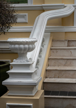 White cement vase as decoration next to the beautiful marble staircase. Roman style ornamental...