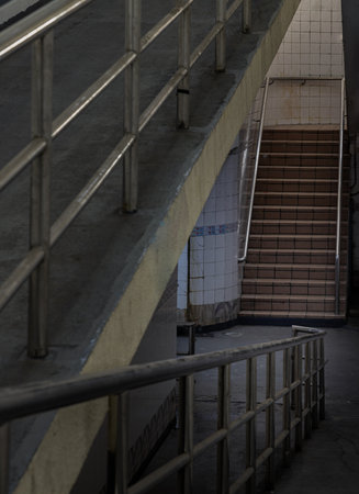 Bangkok, Thailand - Sep 30, 2022 : Stairs leading to interior view of public underpass with white tiled walls and CCTV. Space for text, Selective focus.の写真素材