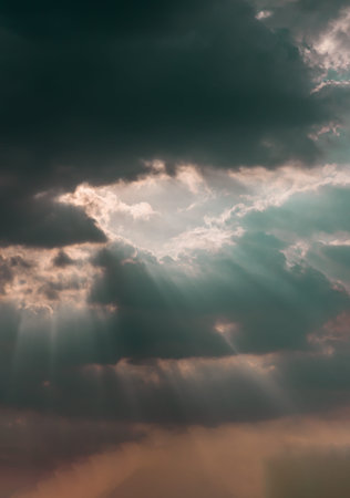 The sun's rays passing through the clouds and shining form an interesting light pattern against the...