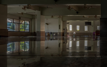 Bangkok, Thailand - 05 Jan, 2022 - Religious muslim man is standing praying inside the mosque. The muslim prayer for god in the mosque. Religion Islam, Space for text. No focus, specifically.のeditorial素材