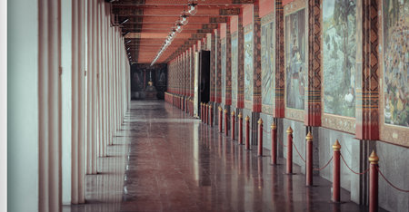 Suphan buri, Thailand Apr 22, 2023 - A Diminishing Perspective Interior View of Walkway at Wat Pa Lelai Worawihan (Pa Lelai Worawihan Temple) with Buddhist Temple Mural Painting Wall Decorated (Khun Chang Khun Phaen classical literature). Thai Art and Arcのeditorial素材