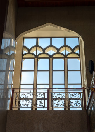 Bangkok, Thailand - June 23, 2023 - The sunshine lights through the glass window frame and there have wrought iron decorative rails patterns in the corridor. Architecture of Interior Building is built for the Islamic Affairs, which is designed with eleganのeditorial素材