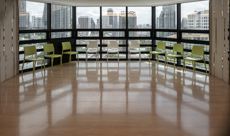 Bangkok, Thailand - 17 Jul, 2023 - Green and White plastic chairs in front of the glass wall. Looking outside through which you can see the of the city view. Copy space, Selective focus.のeditorial素材