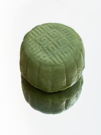 Delicious green mooncake is filled with taro, black sesame and golden thread egg which are reflected...