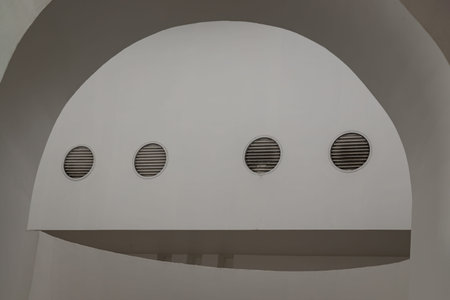 Sunlight shines through white arch interior design and white cement wall. Interior design of white...