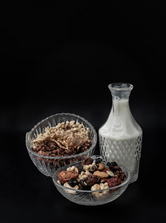 Tasty Gadola, Cereal and Nuts in Glass Bowl served with Almond Milk with Dark Background. Healthy Breakfast, Copy space, Selective focus.の写真素材