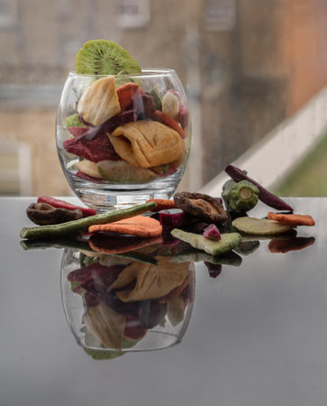 Crispy mixed veggies and fruits in the glass. Different colorful dried fruits and vegetables, Healthy snacks food, Selective focus.の写真素材