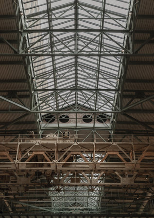 London, UK - Oct 13, 2023 - Interior of Turbine Hall B with an old gantry crane suspending an art installation at New Battersea Power Station now redeveloped as a shopping and leisure destination. The iconic London landmark building, Space for text, Selecのeditorial素材
