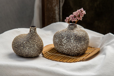 Dried flowers in Handmade Double Ceramic Vases on table. Home decor, Space for text.の写真素材