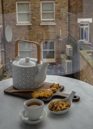 Chinese chrysanthemum flower tea and Dried chrysanthemum flower on wooden cutting board. Healthy beverage for drink. Herbs and medical concept. Space for text, Selective focus.の写真素材