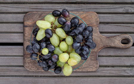 Fresh Green seedless and Black seedless Grapes. grapes healthy fruit ready to eat, View from above, Space for text, Selective focus.の写真素材