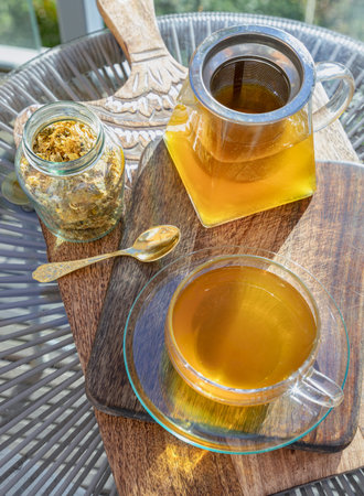 Chinese chrysanthemum flower tea and Dried chrysanthemum flower on wooden cutting board. Healthy beverage for drink. Herbs and medical concept. Space for text, Selective focus.の写真素材