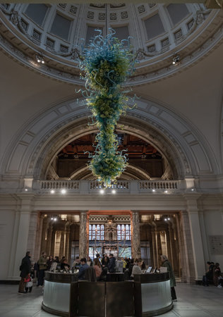 London, UK - Nov 27, 2023 - Metre high, View of Blown glass chandelier in Victoria and Albert Museum hall. Beautiful interior architecture design of The Victoria and Albert Museum. Inner decor. Selective focus.のeditorial素材