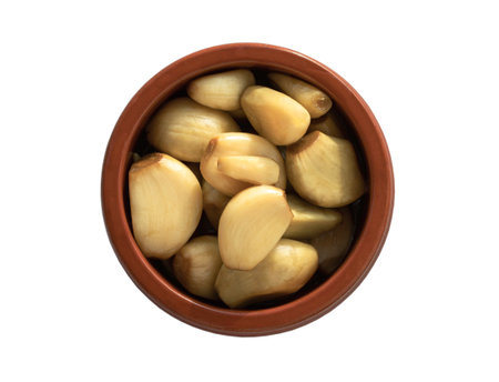 Garlic pickled in Apple cider vinegar with Rock sugar in jar bowl isolated on white background with clipping path. Healthy pickled green and yellow garlic, Garlic cooking, Top view, Selective focus.の写真素材