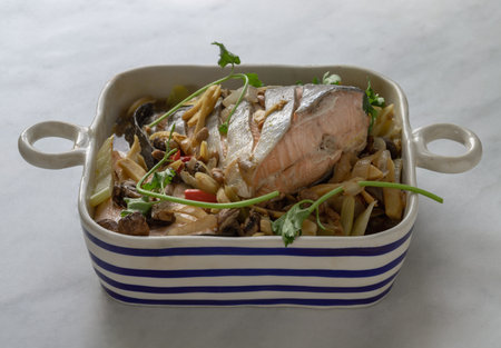 Thai-Chinese style Steamed Salmon with Soy Sauce and Ginger. ingredient include onion, ginger, mushrooms, red chilli, coriander and light soy sauce, Homemade food, Space for text, Selective focus.の写真素材