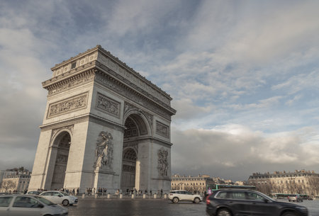 France, Paris - Jan 03, 2024 - Famous Arc de Triomphe (Triumphal Arch) at the city center of Paris and traffic trails in Chaps Elysees. Symbol of the glory and historical heritage, Iconic touristic architectural landmark, Tourism and travel concept, Spaceのeditorial素材