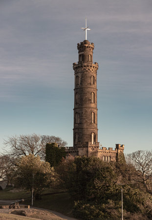 Edinburgh, Scotland - Jan 18, 2024 - Bottom-up view of Nelson's Monument with a bright blue sky in the background. Architecture design of Tower situated on Calton Hill at Edinburgh, Scotland, Space for text, Selective focus.のeditorial素材