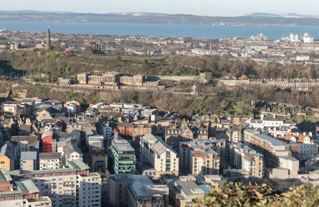 Edinburgh, Scotland - Jan 17, 2024 - Amazing Edinburgh cityscape and Leith docks with the skyline seen from the top of Salisbury Crags. Destinations in Europe, Space for text, Selective focus.のeditorial素材