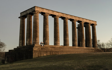 Edinburgh, Scotland - Jan 18, 2024 - A view of the National Monument of Scotland with a bright blue sky in the background situated on Calton Hill at Edinburgh city. Scotland, Space for text, Selective focus.のeditorial素材