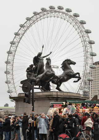 London, UK - Dec 25, 2023 - Bronze Boadicea and Her Daughters sculpture (Queen of the Celtic Iceni tribe) located at the Westminster Bridge with London eye in background. The Chariot of Boadicea, space for text, Selective focus.のeditorial素材