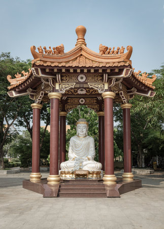 Bangkok, Thailand - Apr 11, 2024 - White Jade Gautama Buddha Statue Sitting on Lotus in pavilion. The Shakyamuni Meditating Buddha at Fo Guang Shan Thaihua Temple, Space for text, Selective focus.のeditorial素材