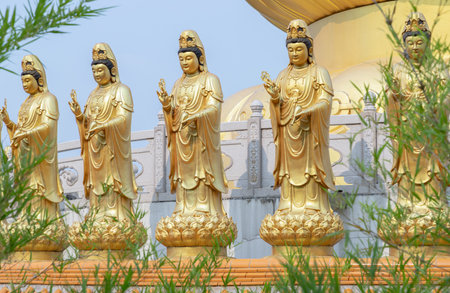 Bangkok, Thailand - Apr 11, 2024 - Golden statue goddess of Mercy Guanyin or Quan Yin statue at Fo Guang Shan Thaihua Temple. Guan Yin Buddha, Taiwanese temple style, Space for text, Selective focus.のeditorial素材