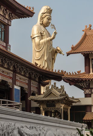 Bangkok, Thailand - Apr 11, 2024 - Big Golden statue goddess of Mercy Guanyin or Quan Yin statue at Fo Guang Shan Thaihua Temple. Guan Yin Buddha, Taiwanese temple style, Space for text, Selective focus.のeditorial素材