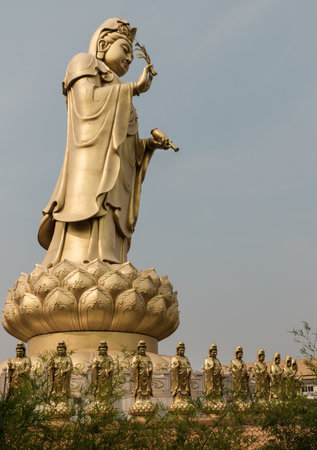 Bangkok, Thailand - Apr 11, 2024 - Big Golden statue goddess of Mercy Guanyin or Quan Yin statue at Fo Guang Shan Thaihua Temple. Guan Yin Buddha, Taiwanese temple style, Space for text, Selective focus.のeditorial素材