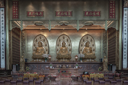 Bangkok, Thailand - Apr 11, 2024 - Three Buddha images inside Fo Guang Shan Thaihua Temple is famous place. Taiwanese temple style, The Institute of Buddhism, Copy space, Selective focus.のeditorial素材