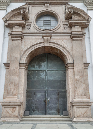 Munich, Germany - Dec 21, 2023 - Entrance iron doorway and Decorated arch wall of St. Michael's Church (Michaelskirche Jesuit church) in Munich pedestrian zone. It is the largest Renaissance church north of the Alps. Space for text, Selective focus.のeditorial素材