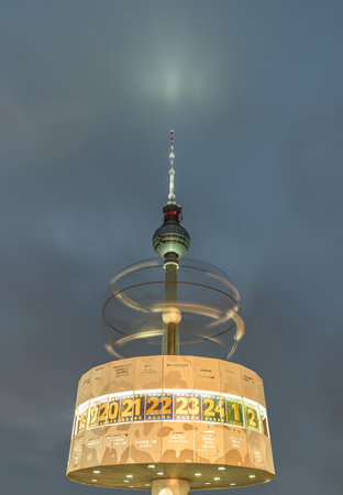 Berlin, Germany - Dec 18, 2023 - Night view of Urania-Weltzeituhr or The World Clock - Revolving sphere in front of Berlin Television Tower (Fernsehturm) near Alexanderplatz square in Berlin, A Tourist attraction and Meeting place, Space for text, Selectiのeditorial素材