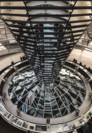 Berlin, Germany - Dec 20, 2023 - Several tourists visitor inside the futuristic glass dome of Reichstag building. Contemporary architecture of the Cupola of the Reichstag dome, a major tourist attraction of the berlin city, Space for text, Selective focusのeditorial素材