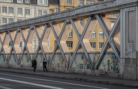 France, Paris - Jan 05, 2024 - People walking along a Bridge on Rue La Fayette. Bridge built above the railways of gare de l'Est, Pont de Lafayette, Rue de l'Aqueduc, Space for text, Selective focus.のeditorial素材