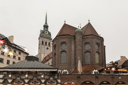 Munich, Germany - Dec 22, 2023 - Marienplatz a central square in the city centre of Munich with St. Peter's Church (Alter Peter) the oldest parish church in Munich. View from the Viktualienmarkt, Space for text, Selective focus.のeditorial素材