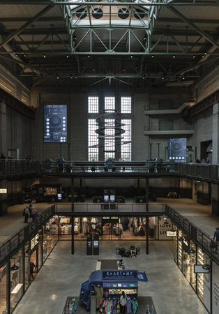 London, UK - Oct 13, 2023 - Architecture interior of Battersea Power Station with The decorative lighting pendants and Oculi at the chimney Lift 109. London's flashiest shopping mall in art deco interior design, Space for text, Selective focus.のeditorial素材