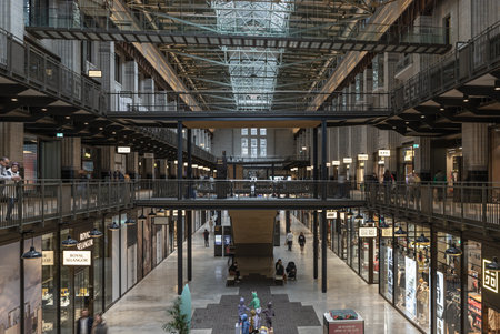 London, UK - Oct 13, 2023 - Tourist people enjoying themselves inside shopping mall on a holiday at Battersea Power Station. London's flashiest shopping mall in art deco interior design, Space for text, Selective focus.のeditorial素材