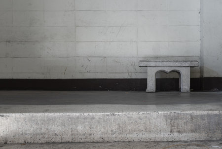 Old concrete texture wall with a old marble bench in front of it. Space for text, Selective Focus.の写真素材